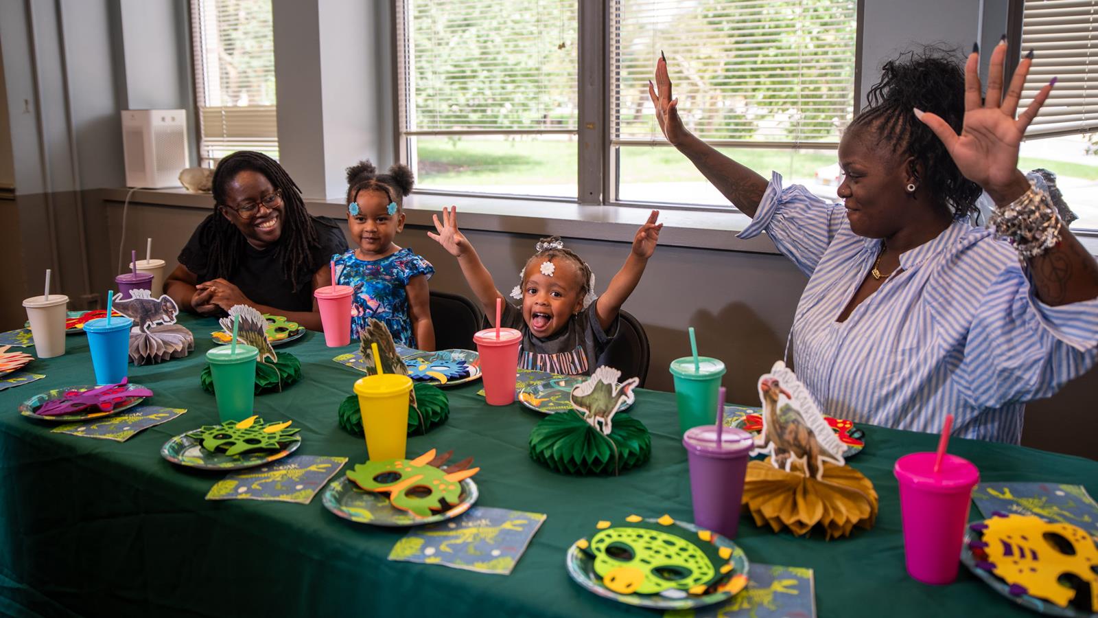 A group of people celebrating at a birthday party.