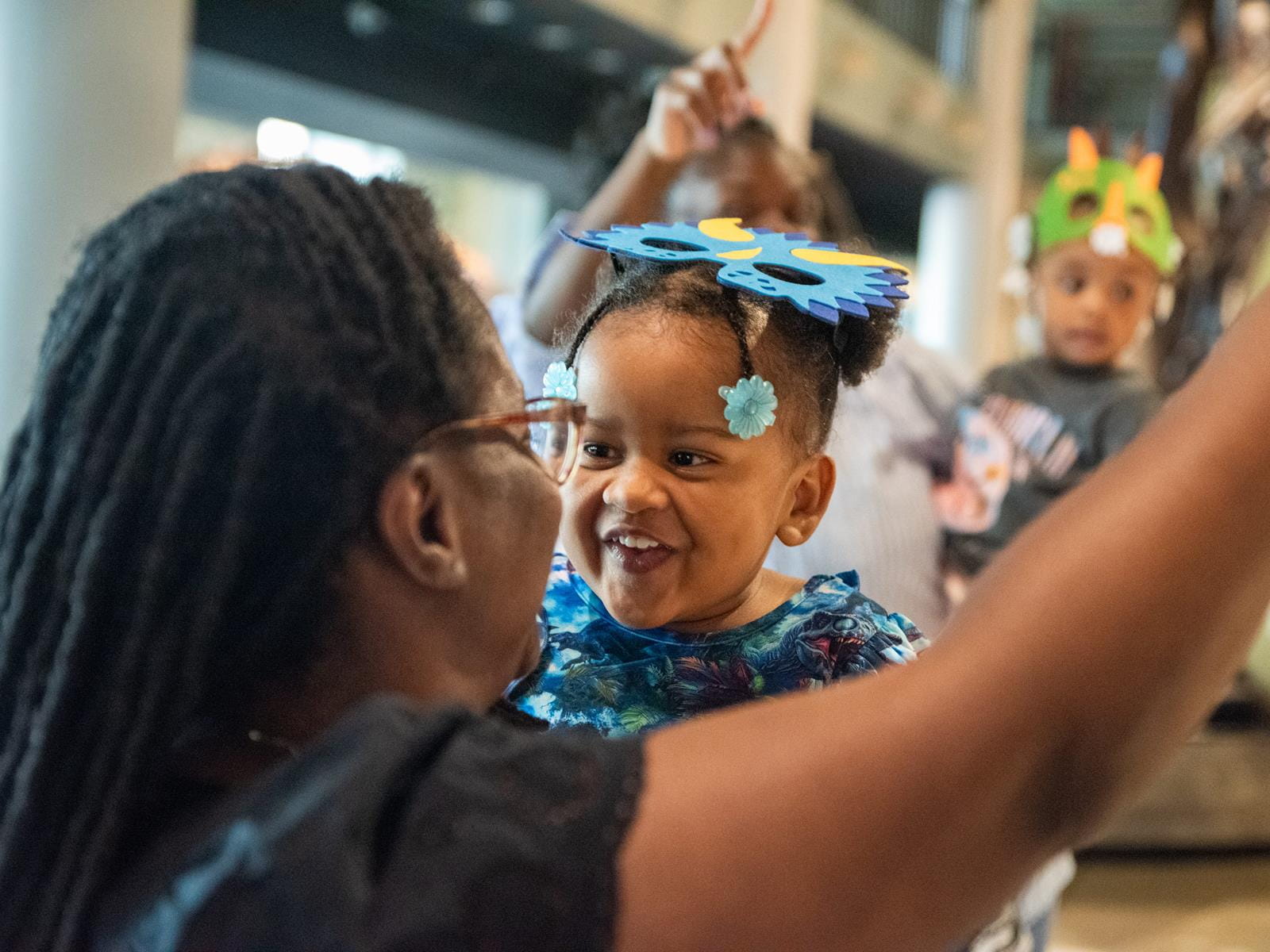 A child looking at their parent smiling.