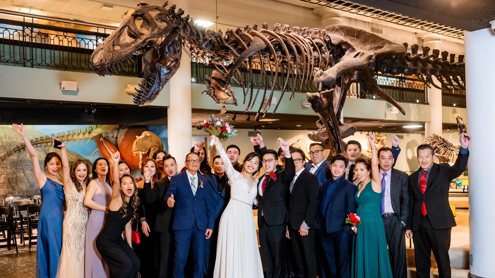 A wedding party under the T-rex.