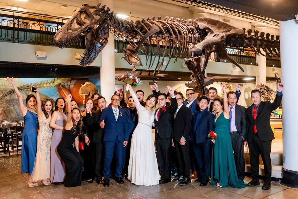 A wedding party under the T-rex.