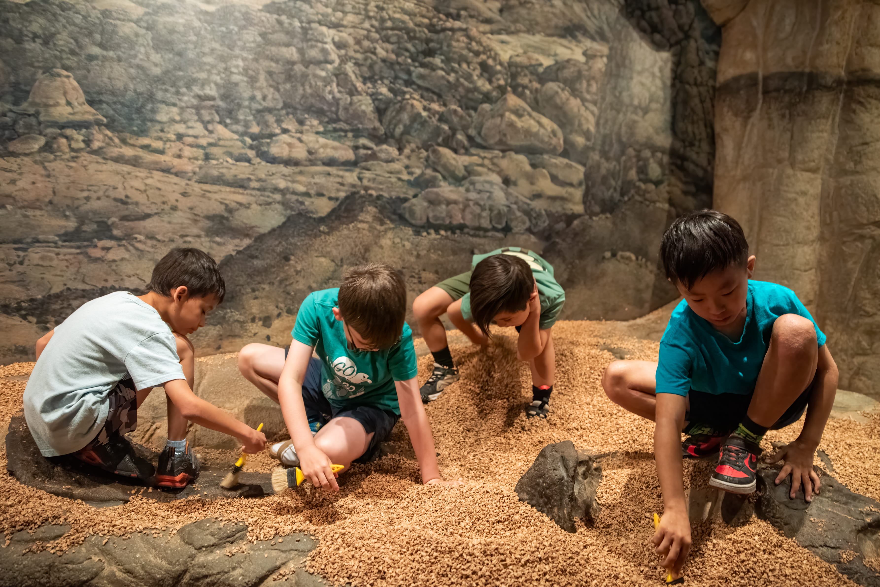 Several children looking for fossils in the big dig.