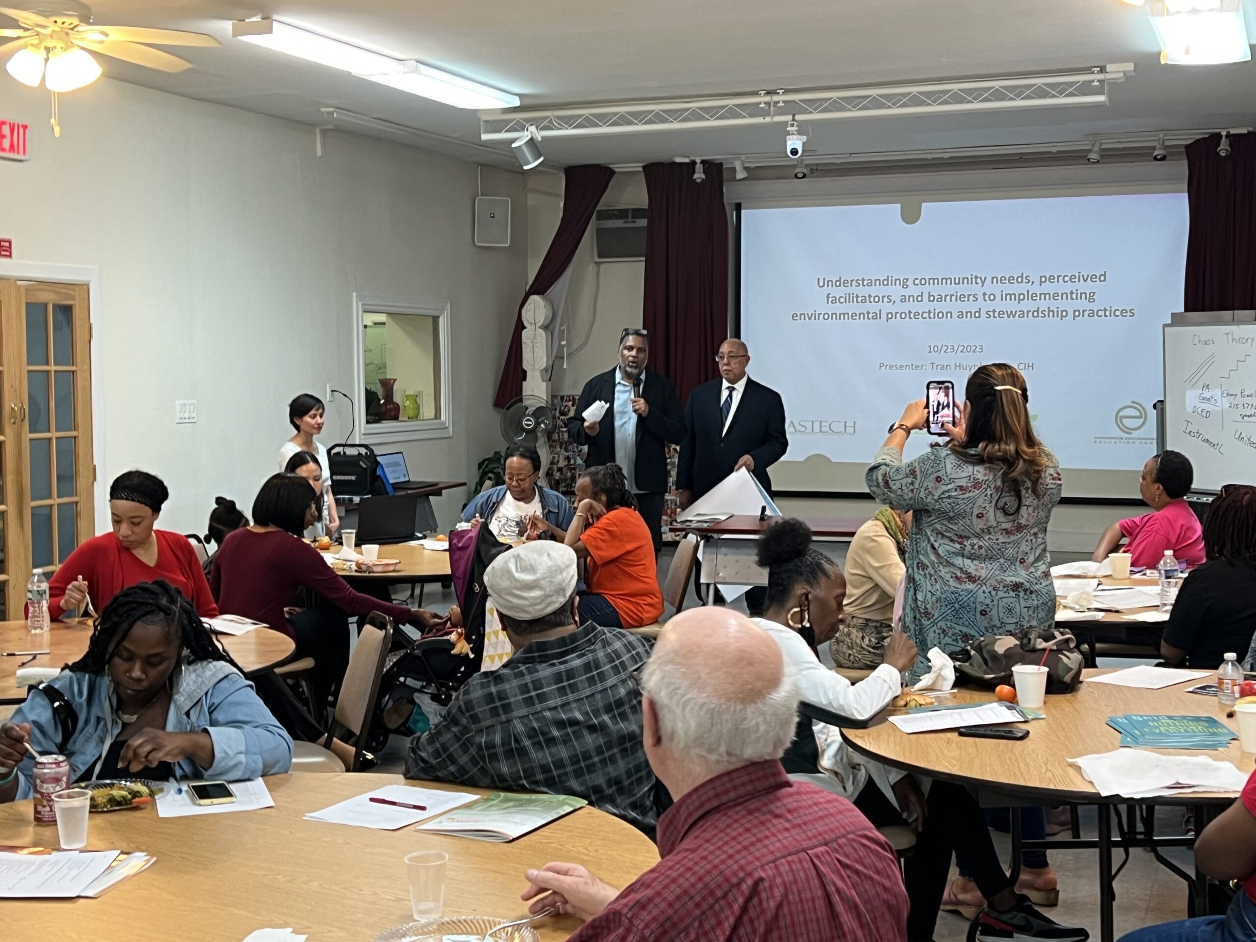 A group of people in a room during a presentation.