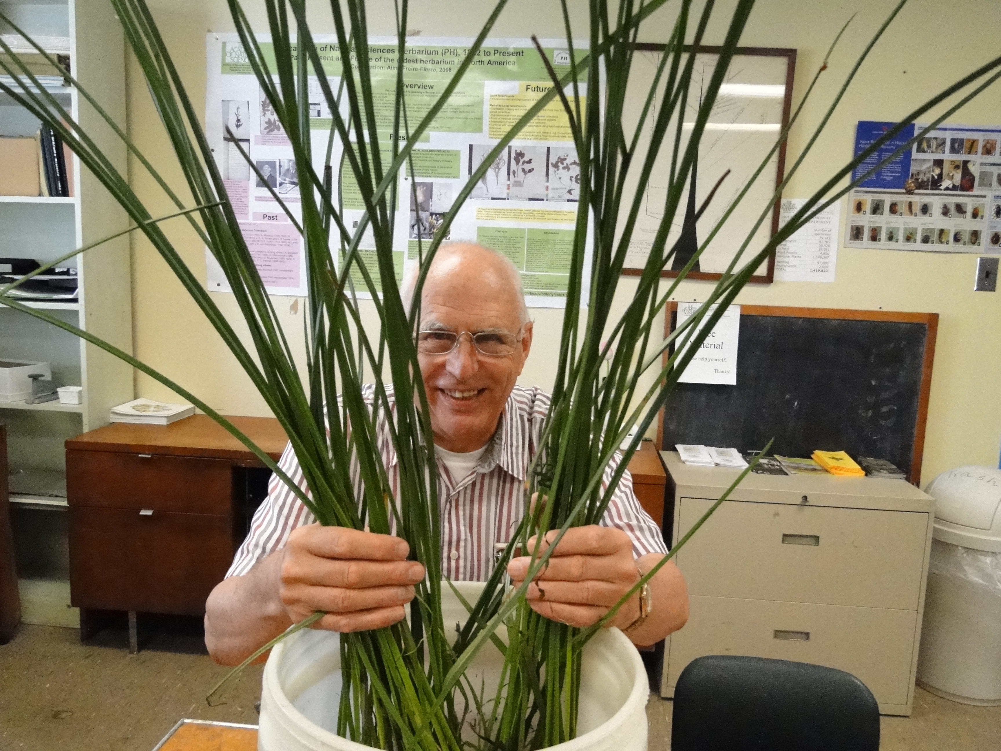 Staff scientist Ernie Schuyler hiding behind a plant.