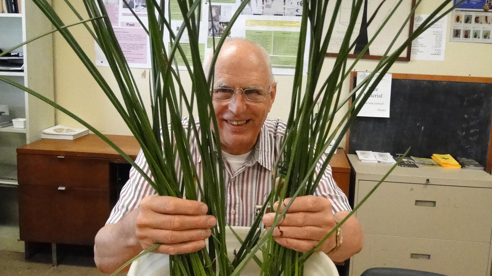 Staff scientist Ernie Schuyler hiding behind a plant.