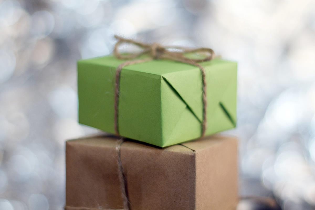 A green and brown present wrapped and stacked un top of each other.