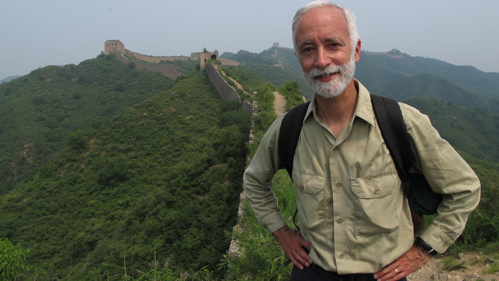 Bob Peck standing on top of the Great Wall of China.
