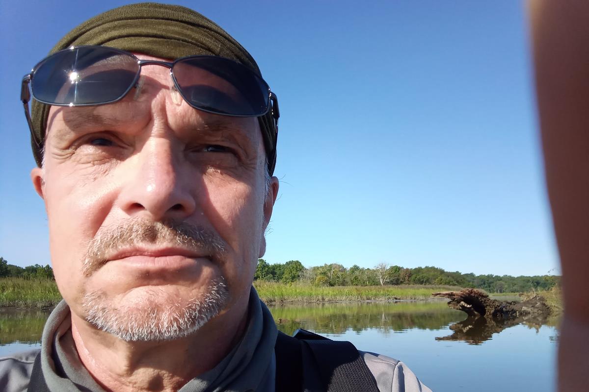 Academy scientist Roland Wall, adjusting a camera.