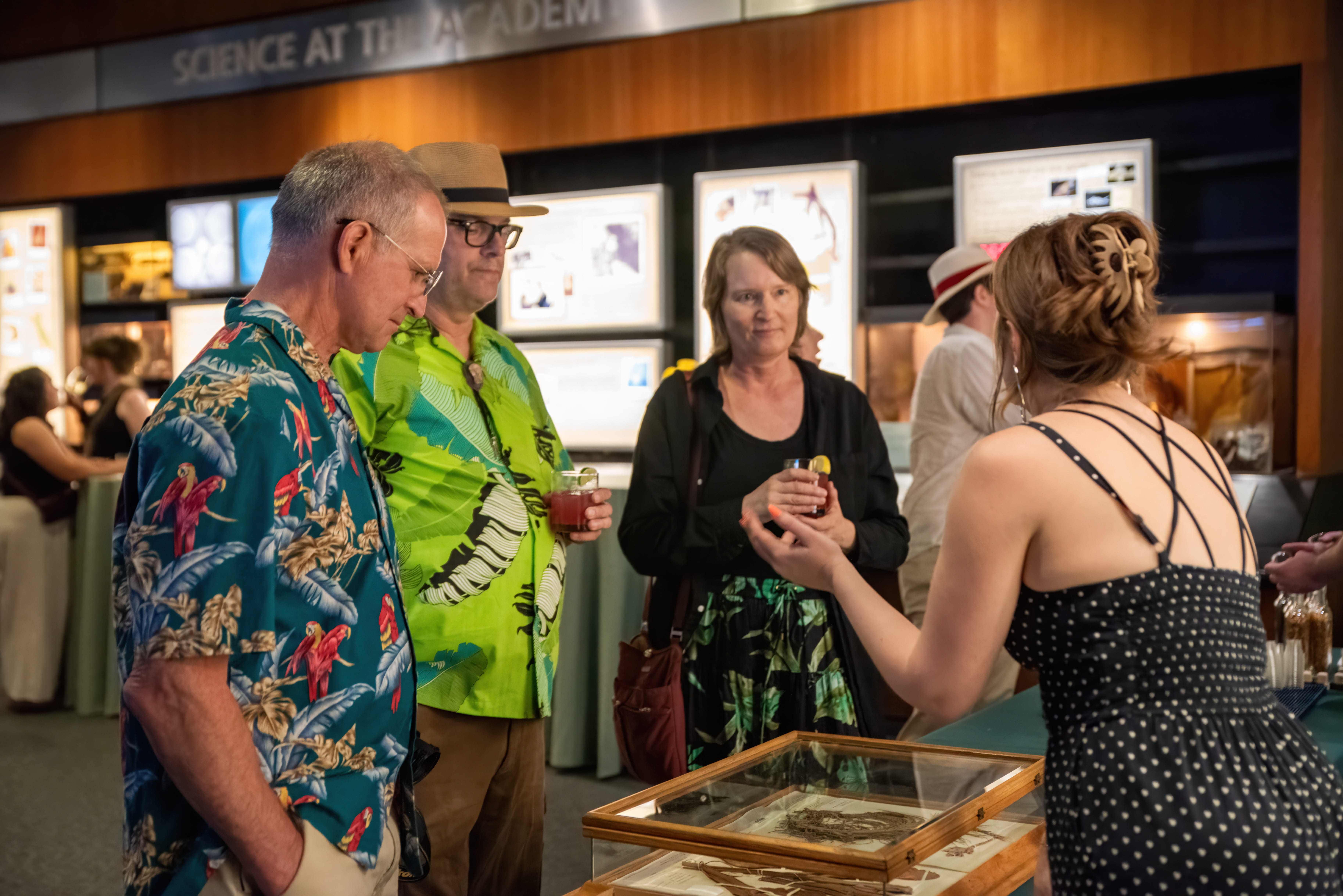 An academy scientist shows specimens to guests.