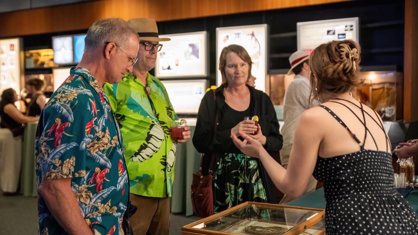 An academy scientist shows specimens to guests.