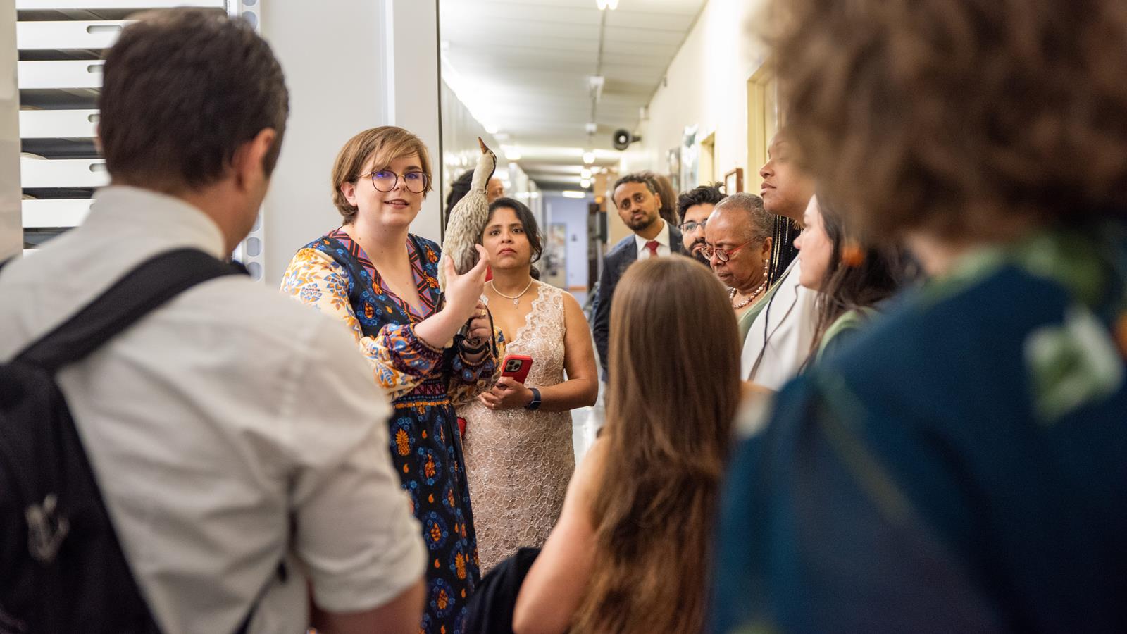 An Academy scientist showing off a specimen to a group of visitors.