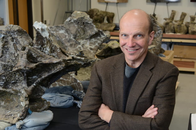 Ken Lacovara in front of a vertebrae