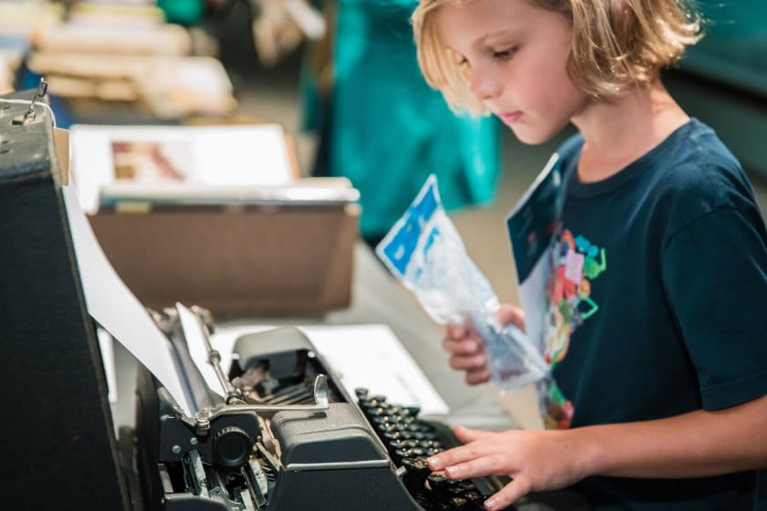 Child uses typewriter