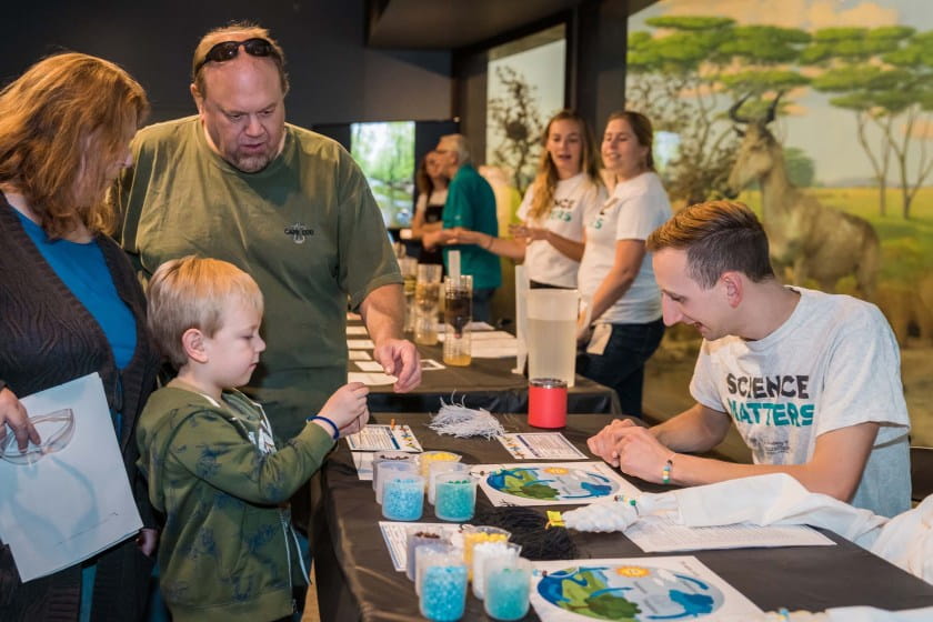 Young boy does experiment with scientist