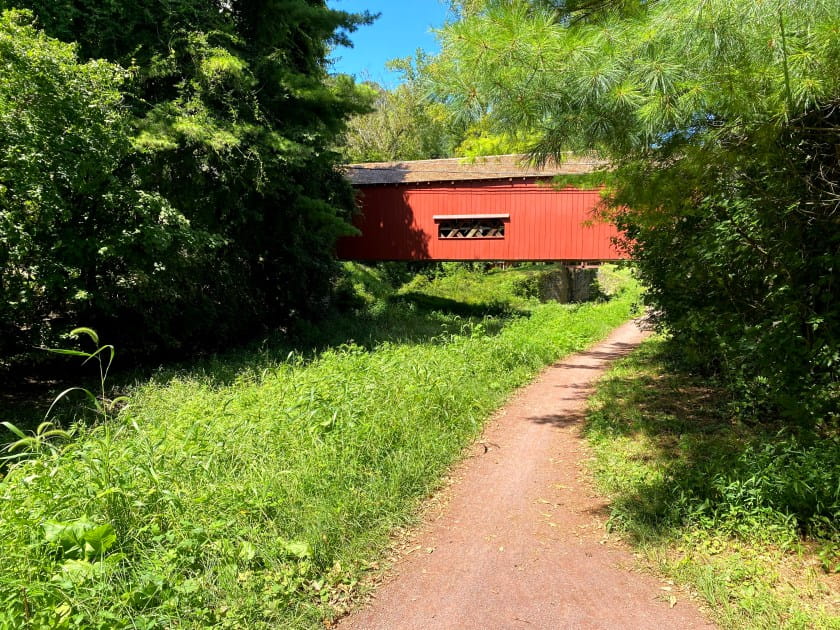 covered bridge along a dirt path