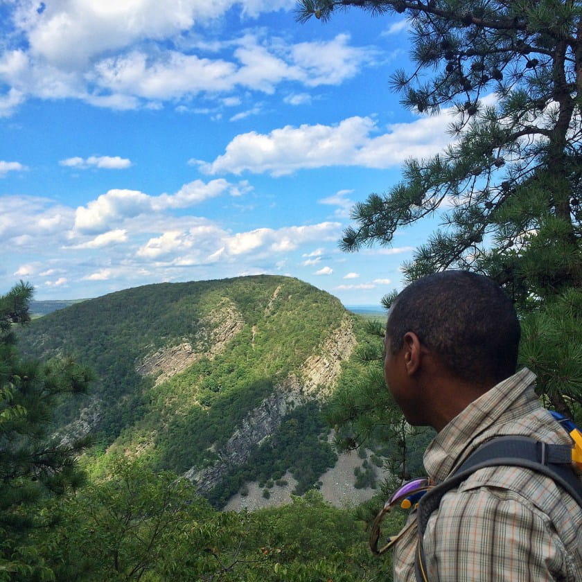 man looking out at mountain vista