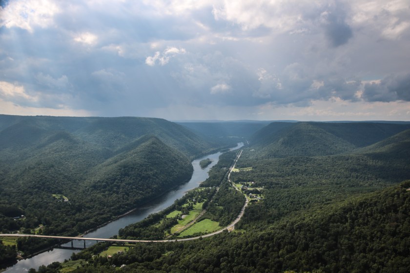 view from vista looking at green mountains with bridge below