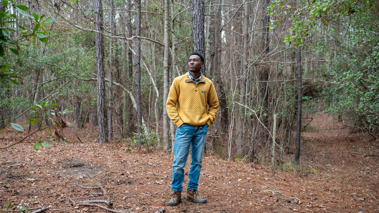 Isaiah Scott standing in the woods