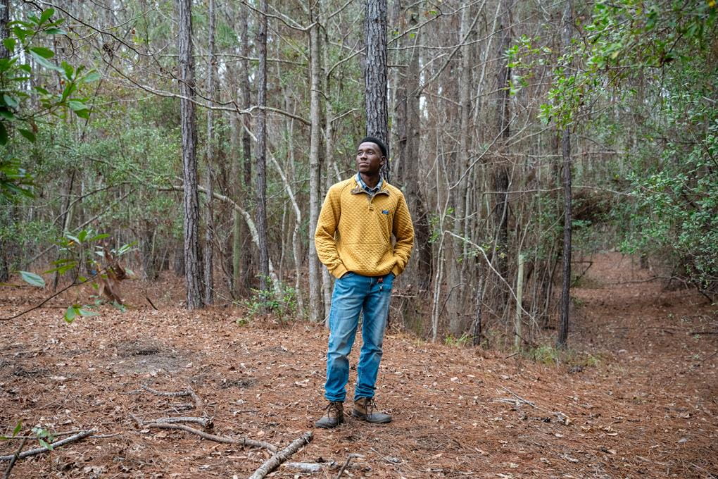 Isaiah Scott standing in the woods