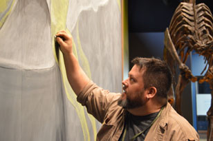 Artist Jason Poole sketches Haddy. Photo by Lauren Duguid/ANS