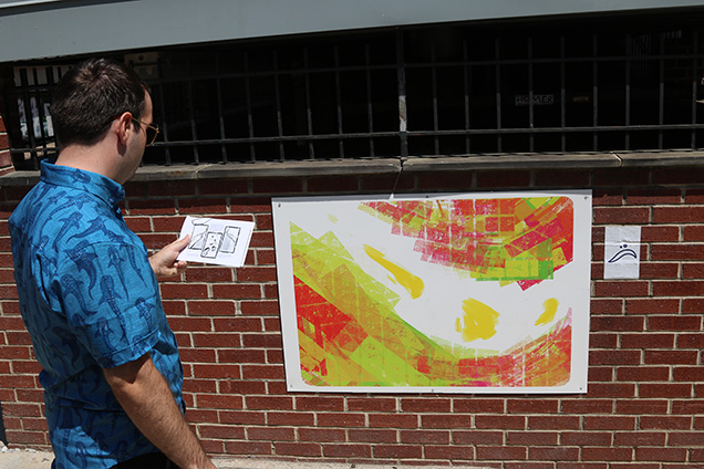 A person looking at map in front a mural