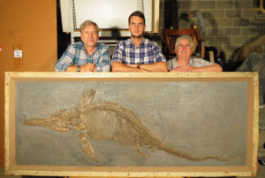 3 scientists with fossil