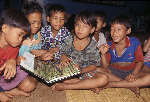 boys in Borneo reading a book