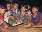boys in Borneo reading a book