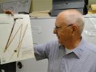 Ernie Schuyler and a herbarium sheet containing a speciment of the delta bulrush