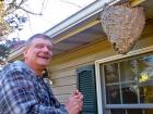 Paul Kiry next to the hornet nest at his home