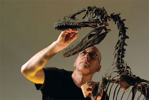 exhibits staff repairing a dinosaur mount