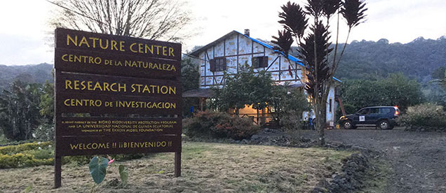 building with sign for nature center outside with tropical trees
