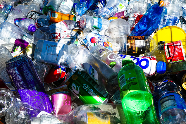 A variety of different bottles and cans being recycled.