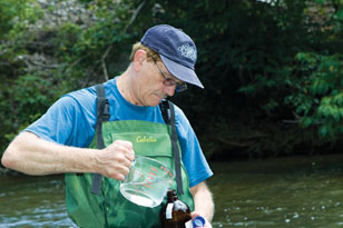 environmental chemist Paul Kiry taking water quality samples