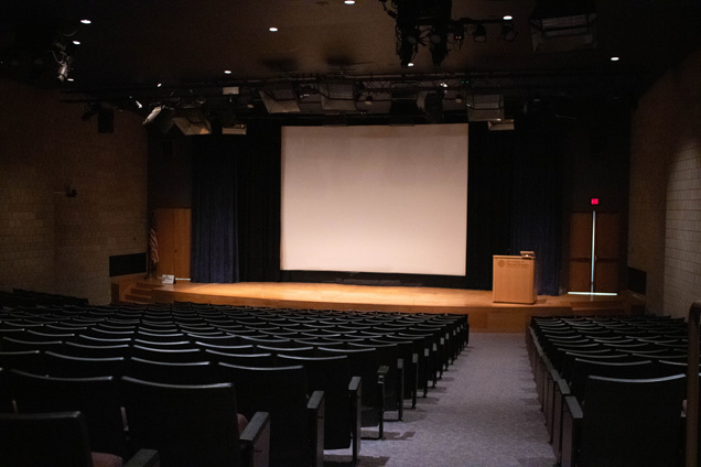 The Academy's Auditorium with a giant white projector screen.