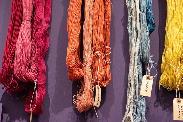 A group of colorful threads on a wall.