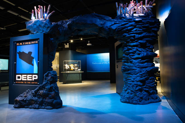 entrance to extreme deep exhibit with underwater looking rocks and blue light